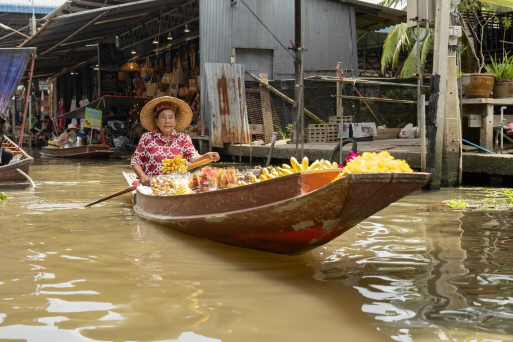 Discover the vibrant atmosphere of Bangkok's floating markets with traditional Thai produce and culture.